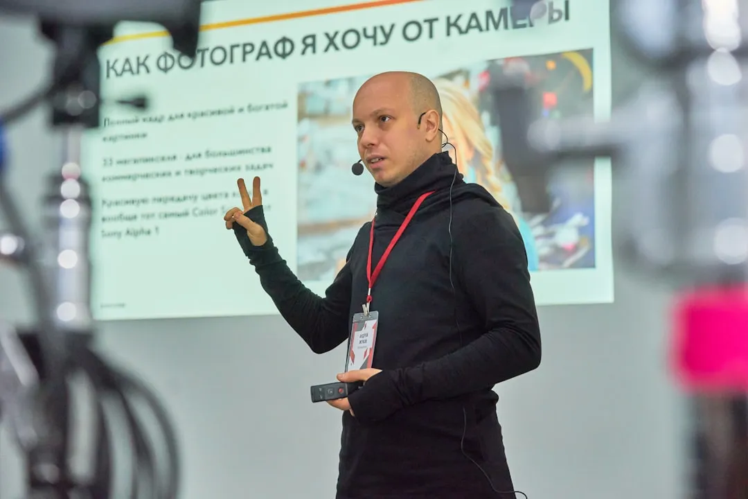 A man standing in front of a projector screen
