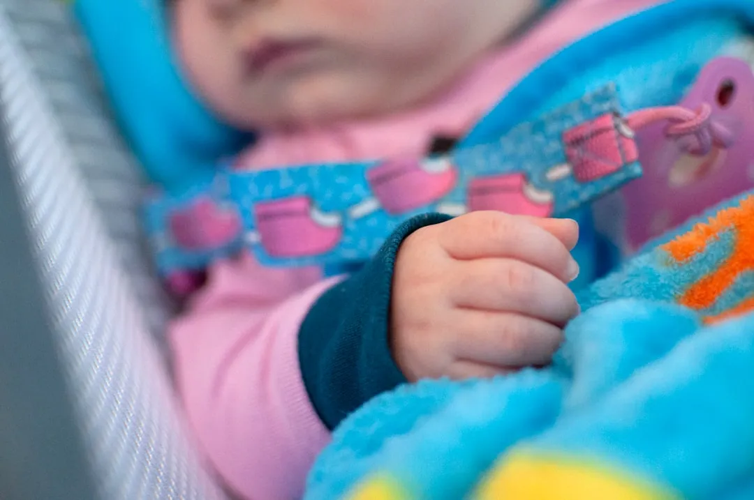 baby in blue and pink shirt