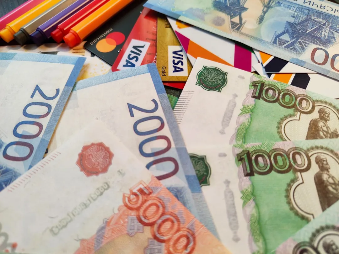 a pile of different currency sitting on top of each other