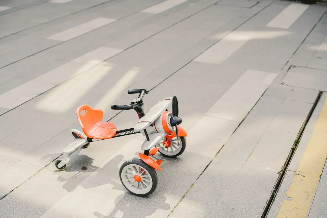 red and white motor scooter on gray pavement