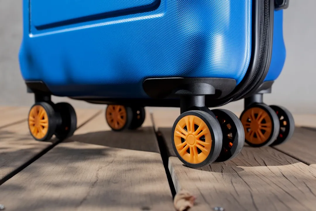 a blue piece of luggage sitting on top of a wooden floor