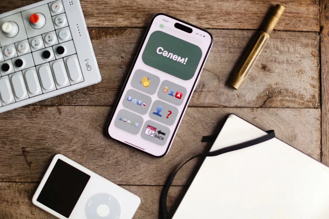Phone, music player, and more on a wooden table.
