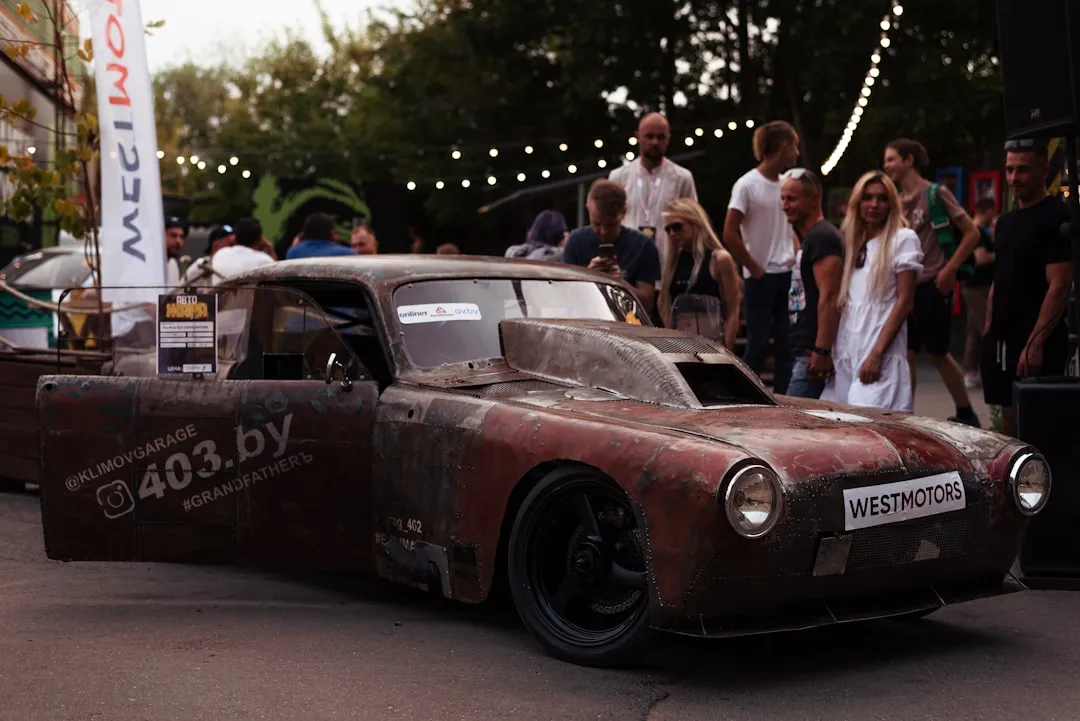 a group of people standing around a car