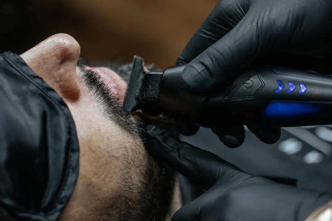 a man getting his hair cut with a hair dryer