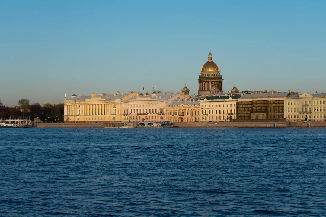 a large body of water with buildings in the background