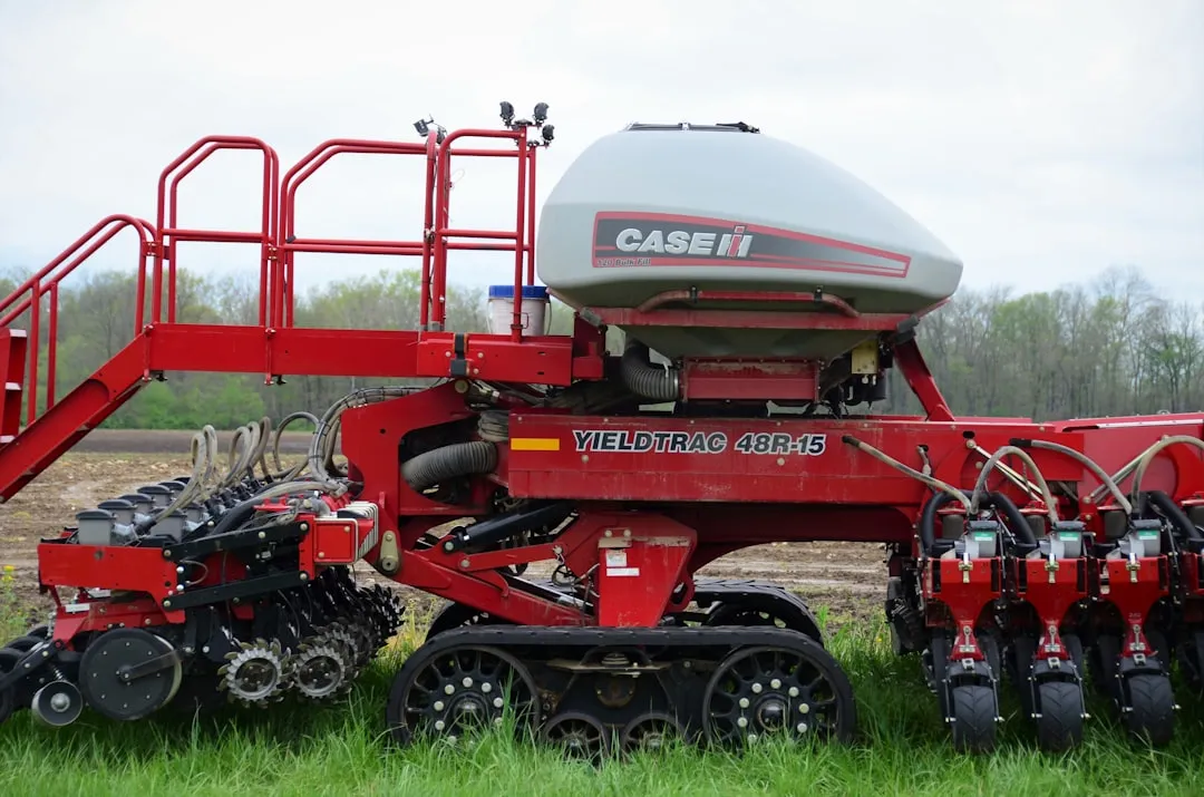 a red and black machine on grass